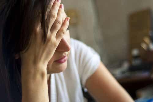 Mujer cansada con dolor de cabeza por déficit de magnesio