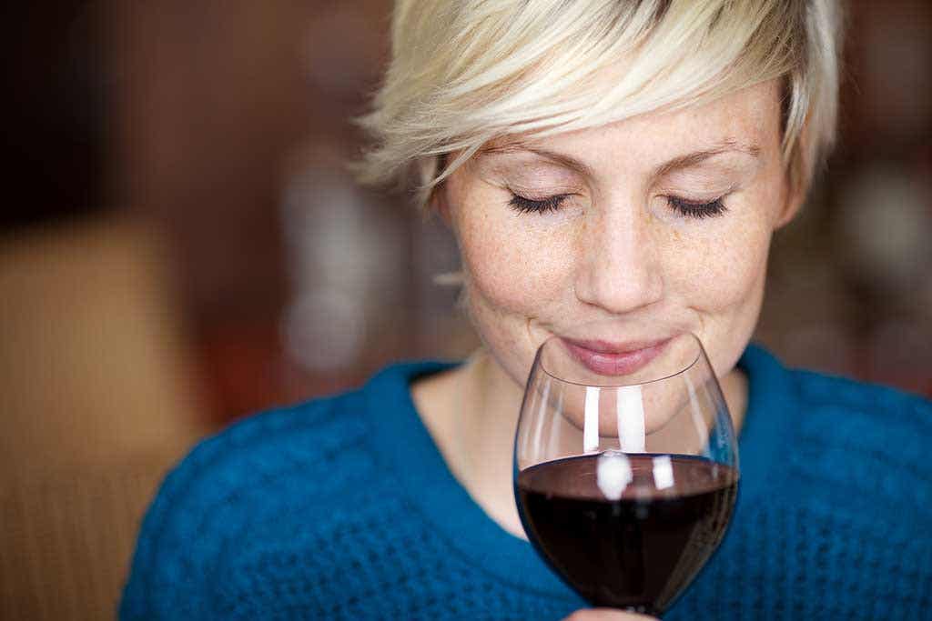 A woman drinking wine.