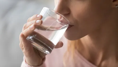 A woman drinking water.