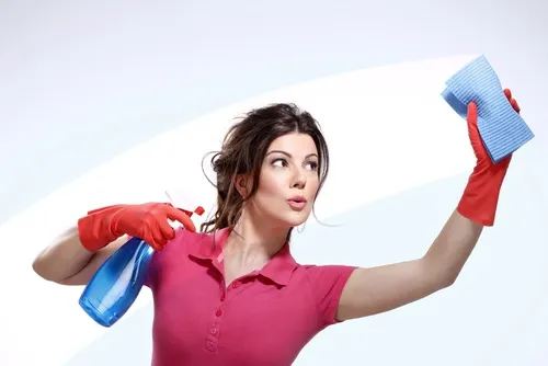A woman cleaning glass with a sponge