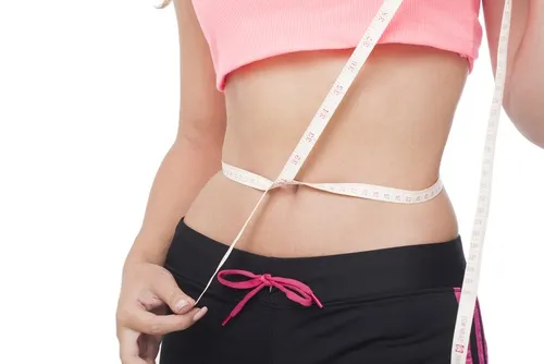 Girl measuring her waist