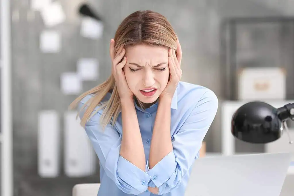 A woman with a migraine.