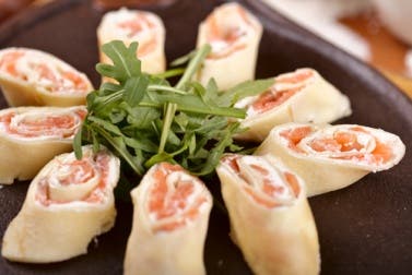Rollitos de pan de molde con salmón y rúcula