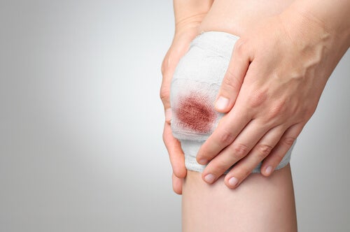 Remove the bandage from a bleeding wound