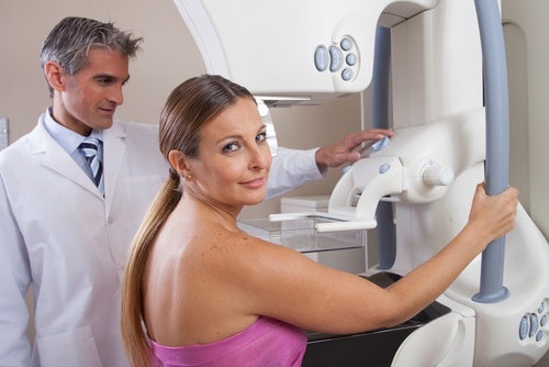 A woman getting a first mammogram