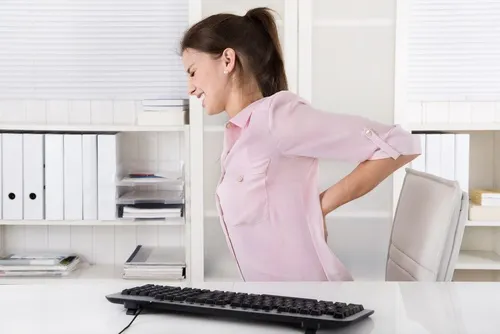 femme souffrant de maux de dos au bureau
