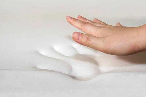 Person laver håndaftryk i hvidt stof
