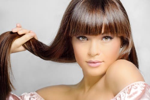 Mujer sujetándose el cabello.