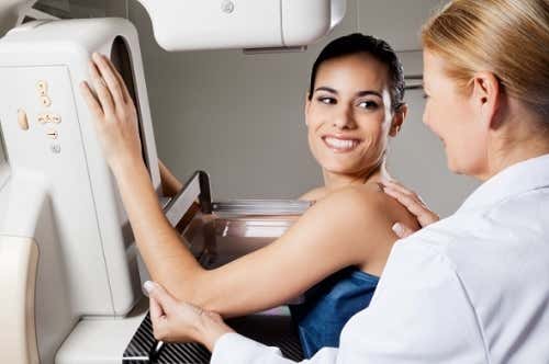 A woman getting a first mammogram 