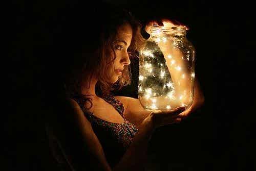 A woman looking at fireflies.