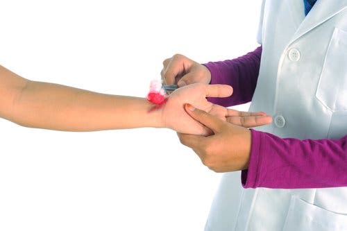Sanitario curando una herida con antiséptico