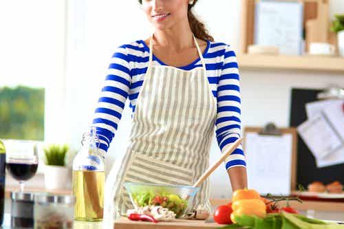 Mujer en la cocina preparando verduras como consecuencia de su ortorexia