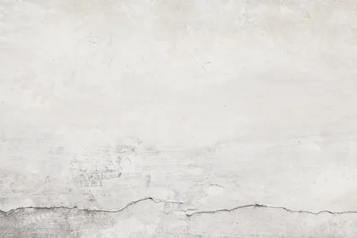 Pared con grietas a imperfecciones.