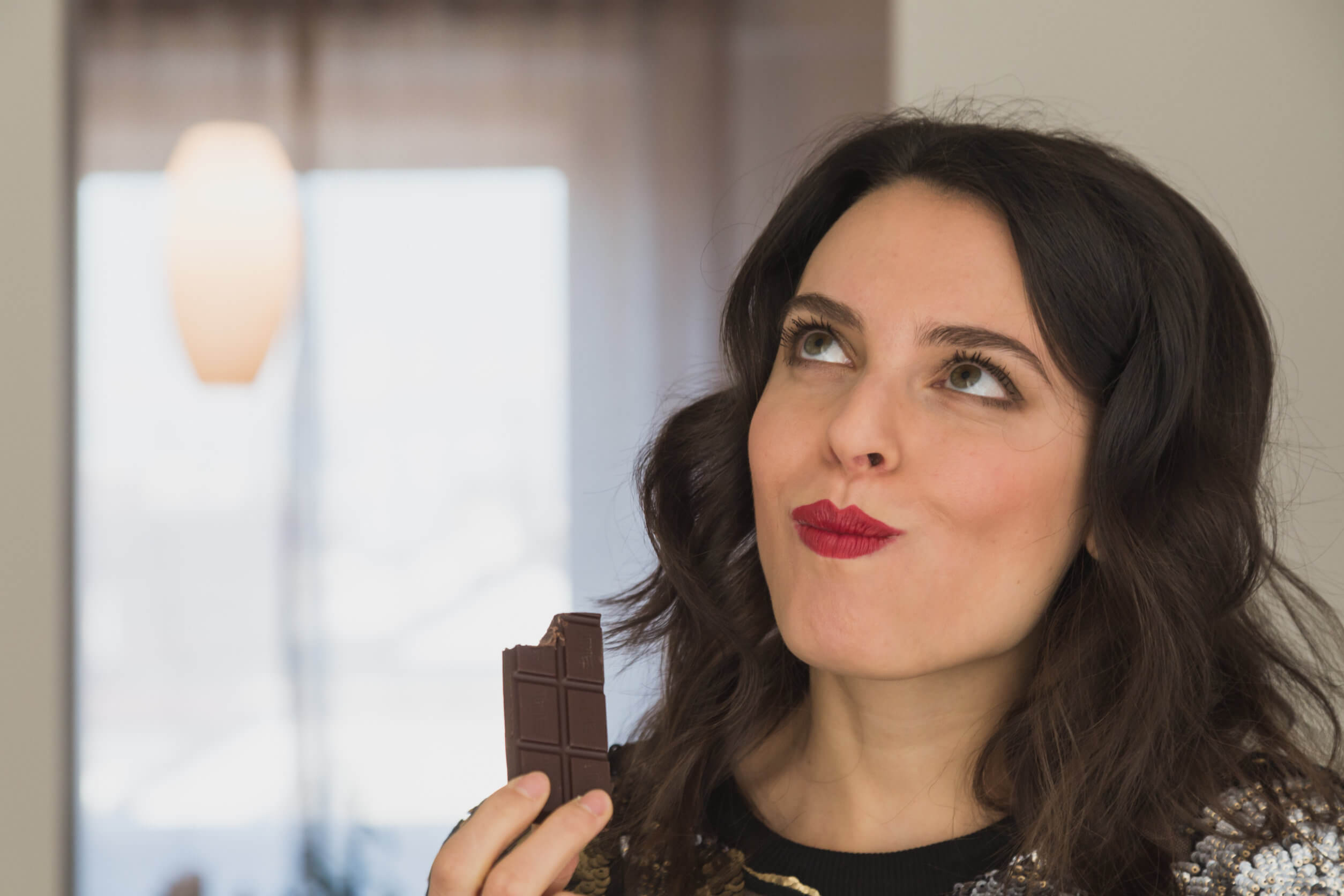A woman eating chocolate.
