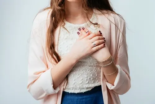 Kvinde tager sig til hjertet