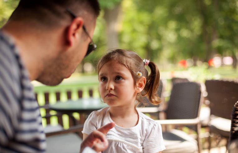 Padre riñendo a su hija para poner límites.