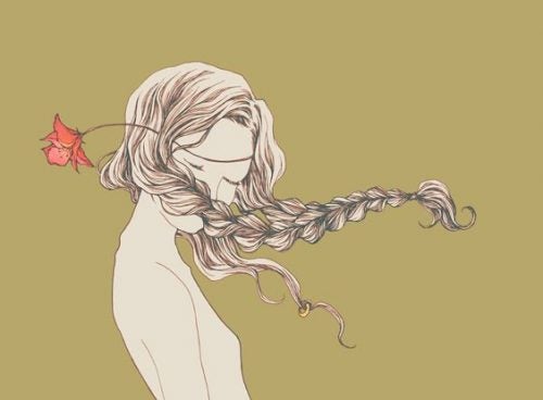 Mujer con el pelo al viento y una flor 