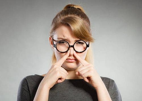Mujer tapándose la nariz