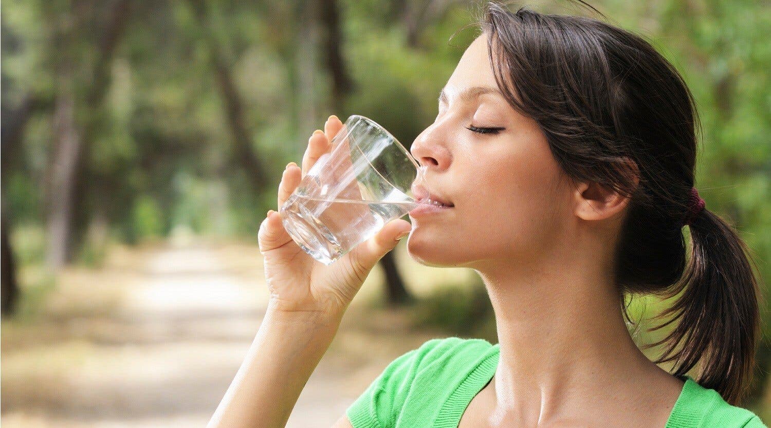 young woman drinking with waterglass