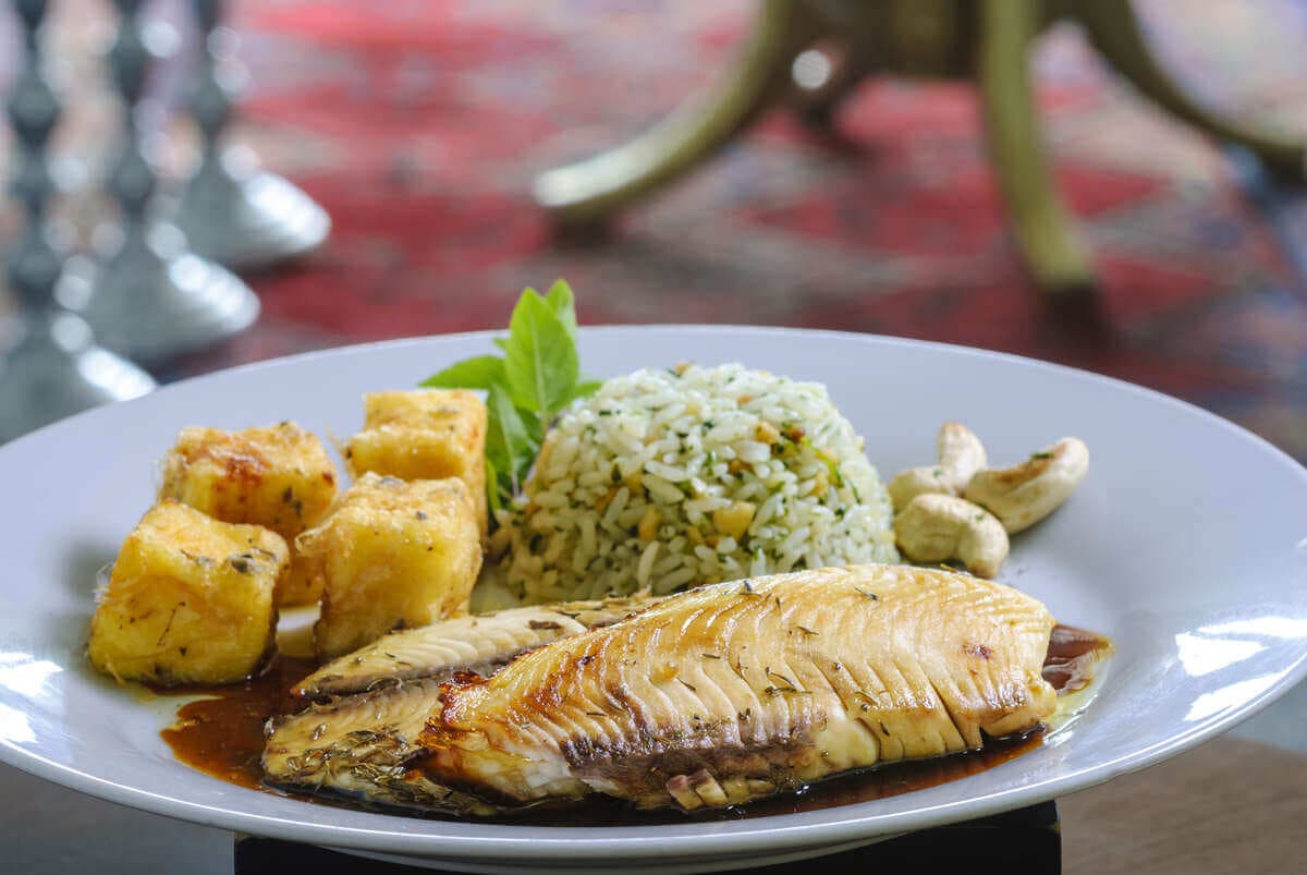 Tilapia cocida con arroz y cubos de queso