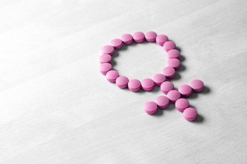 Símbolo femenino con pastillas rosas