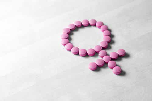 Símbolo femenino con pastillas rosas