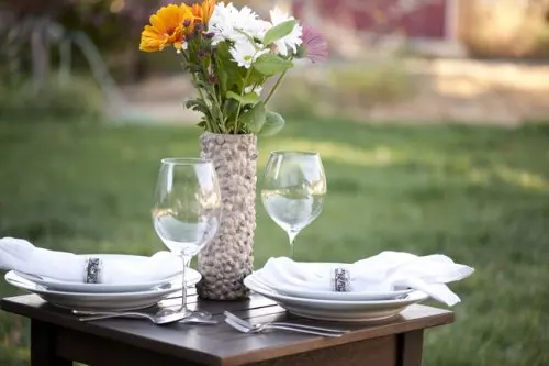 Florero con tubo de cartón sobre una mesa elegante