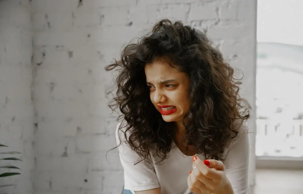 Mujer con cara de asco como emoción primaria.