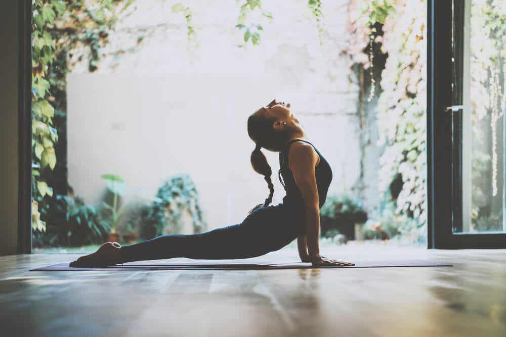 Mujer practicando las posturas de yoga para la felicidad