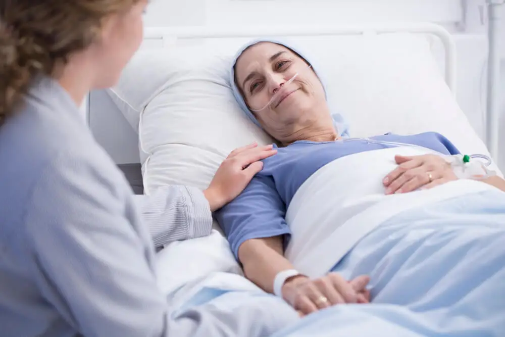 A sick woman in a hospital bed.
