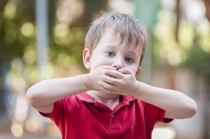 A child covering their mouth.