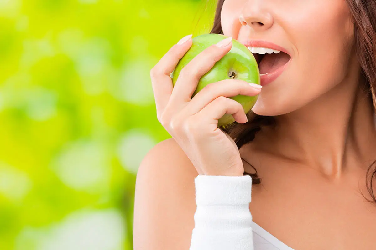 A woman eating and apple