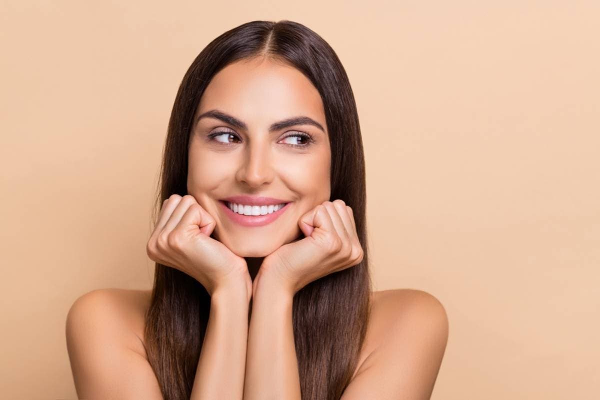 Joven aplicándose crema para conseguir un excelente bronceado.