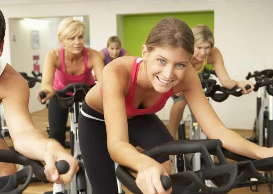 Mulheres em uma sessão de bicicleta ergométrica.