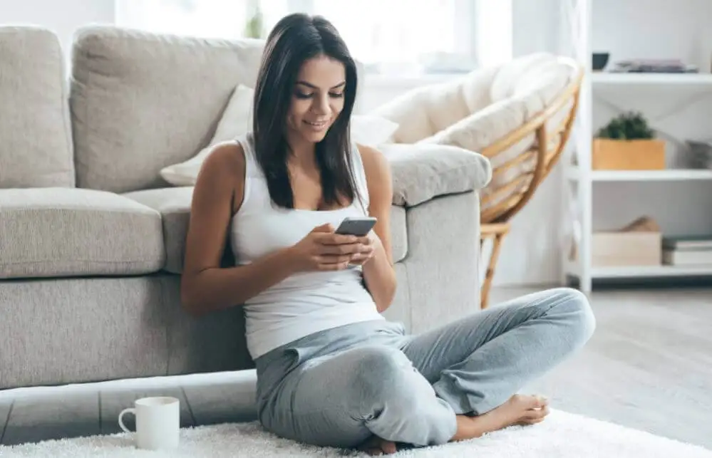 A woman looking at phone in free time