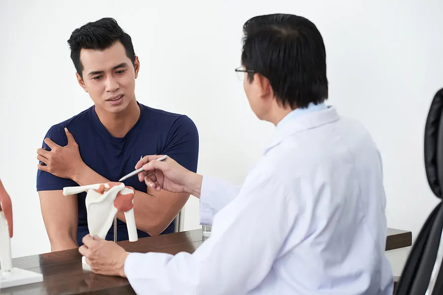 a doctor with a man with shoulder calcification