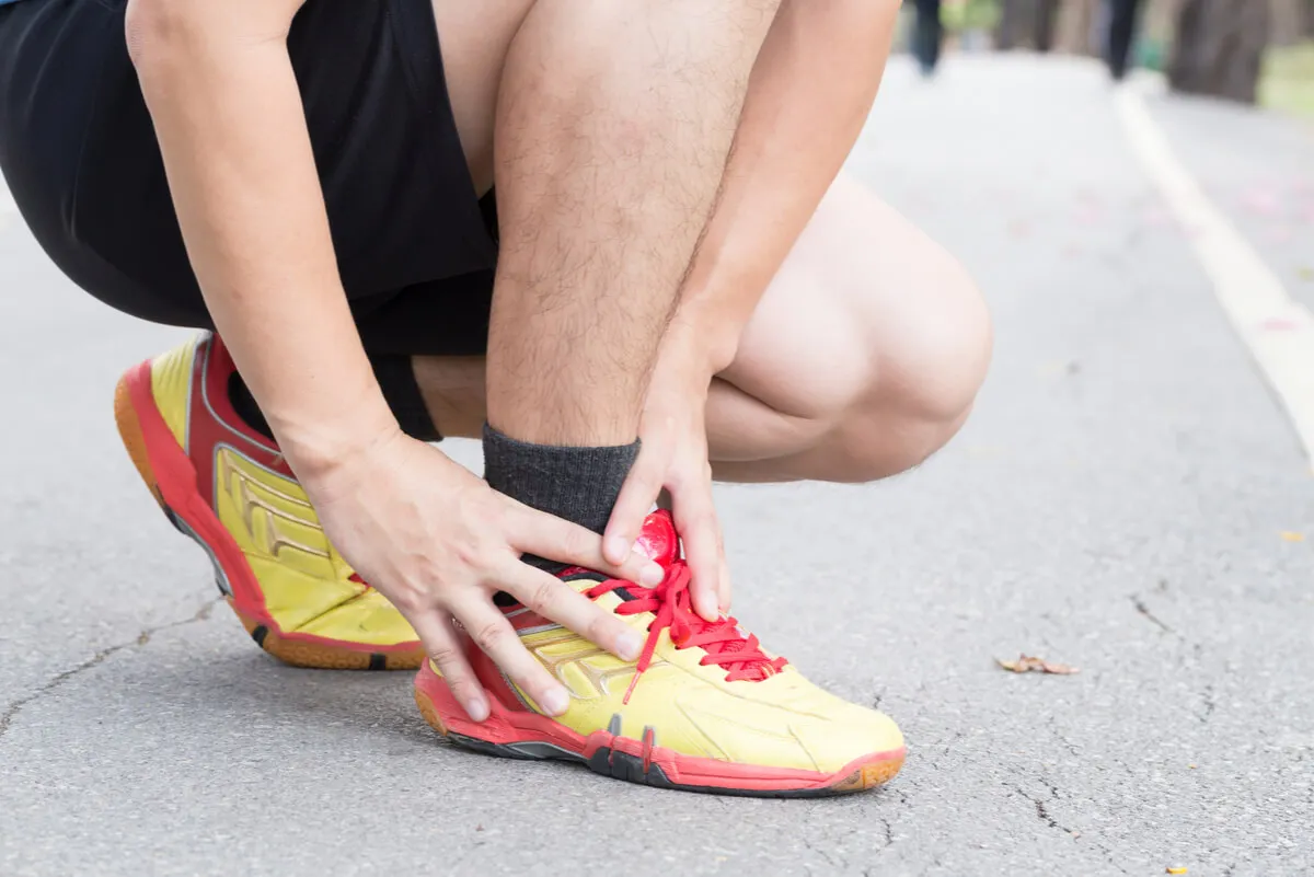 Deportista con dolor de tobillo.