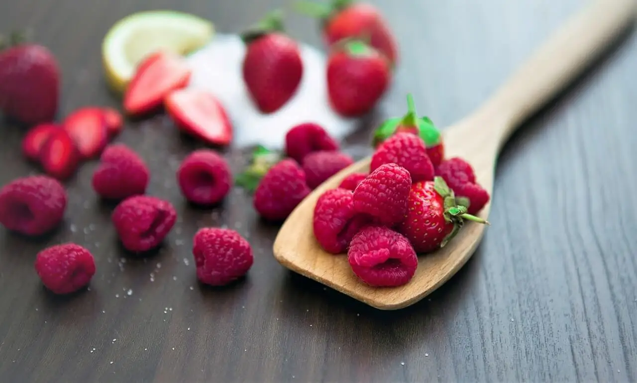 Frutos rojos en una cuchara de madera.