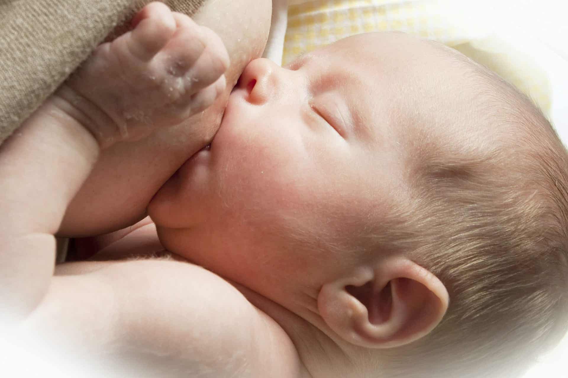 A baby breastfeeding.