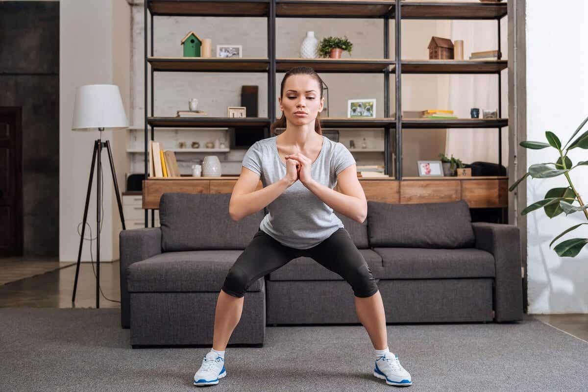 A woman doing squats.
