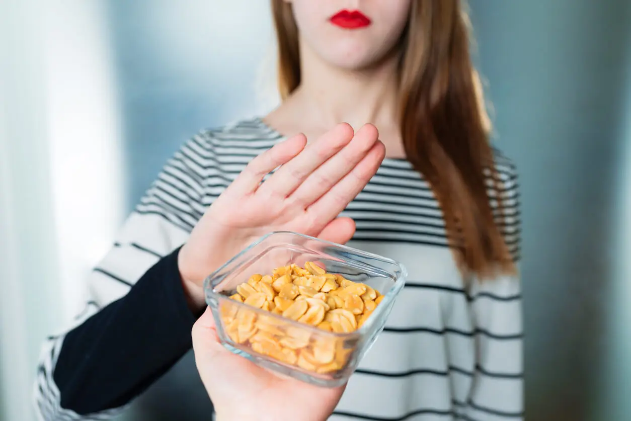 A woman removing peanuts.