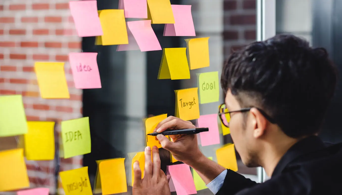 Moodboard - Mann beschriftet verschiedene Post-its