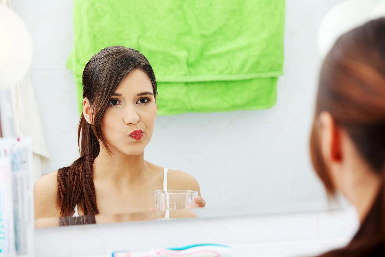 A woman rinsing her mouth.