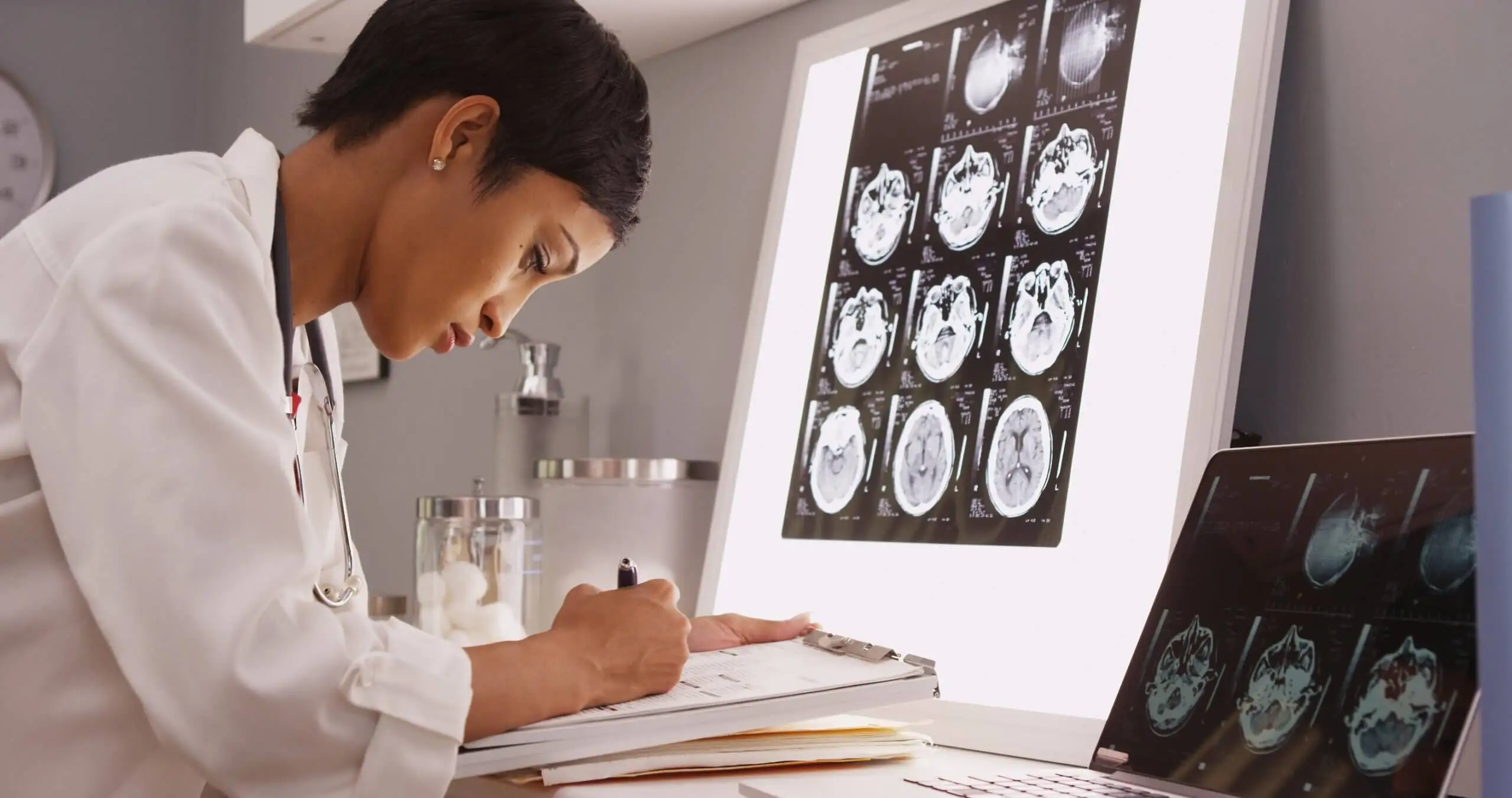 A doctor studying scans.
