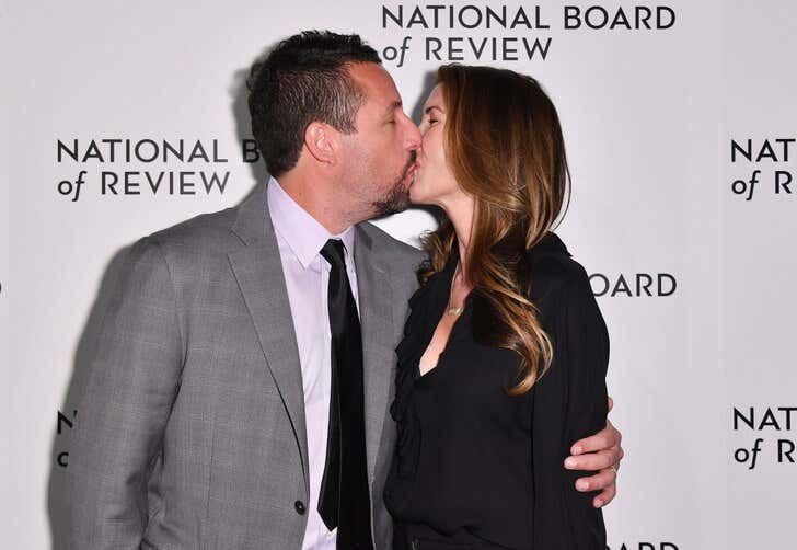 Adam Sandler kissing his wife.