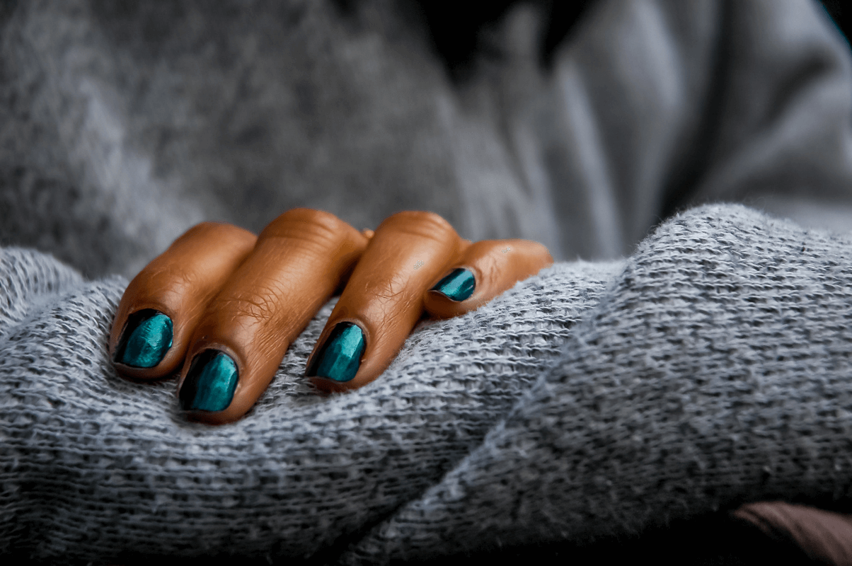 Mujer morena con estilo emerald green nails.