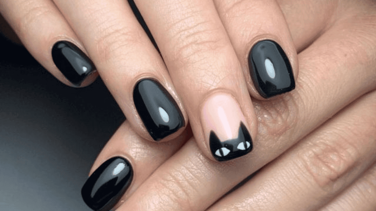 Uñas negras con detalle de gato en dedo medio.